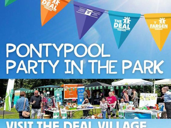 Colorful “Deal” banners above stalls at Pontypool Party in the Park