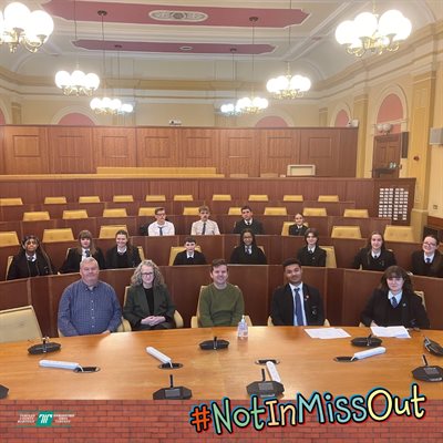 Pupils of Croesyceiliog school in the council chamber with #NotInMissOut written on the image