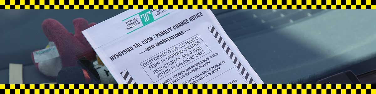 Parking enforcement notice on a car windscreen