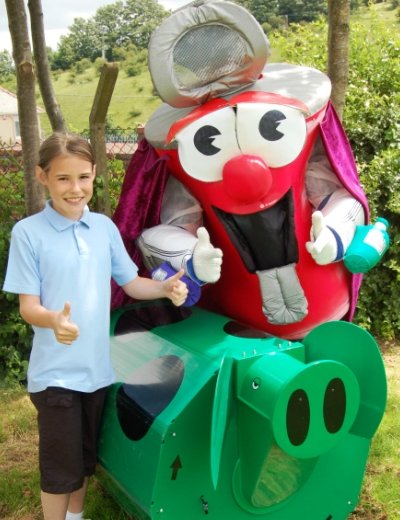 Dan presents a Rolypig Compost Bin to Pontymoile School pupil Laura Honeybun, who won a rap competition in the Trash Times