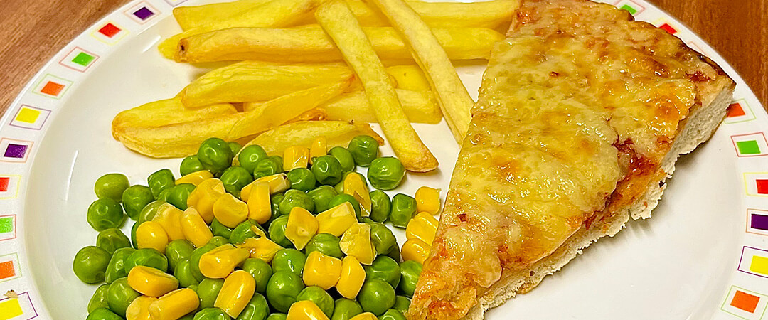 Cheese and tomato pizza served with chips, peas and sweetcorn