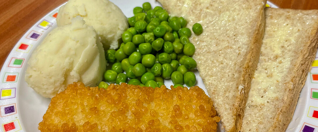 Double bubble salmon fillet served with mash, peas and garlic bread