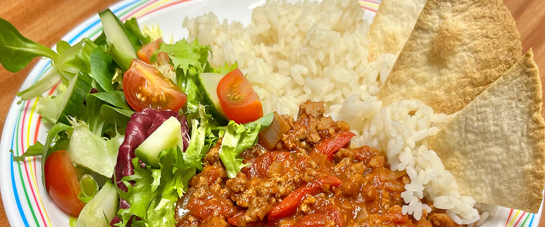 Homemade BBQ Quorn served with rice, tortilla chips and salad