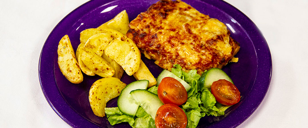 Cheese and tomato pizza with potato wedges, baked beans or peas