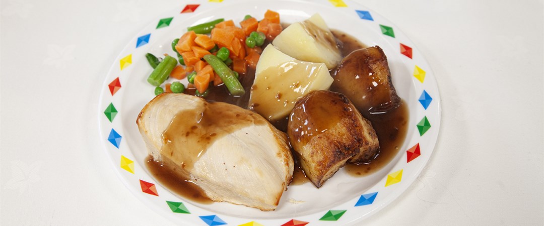 Roast chicken with stuffing, roast and boiled potatoes, veg selection and gravy