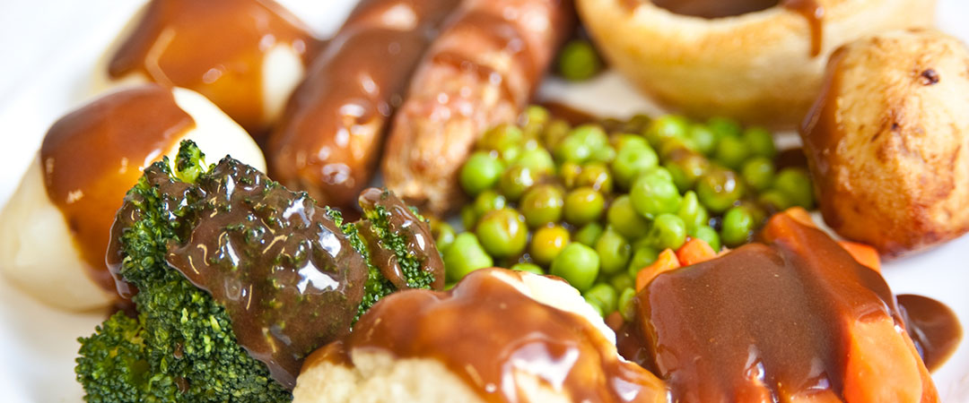Pork Sausages with Yorkshire Pudding, Roast and Boiled Potatoes, Vegetables and Gravy