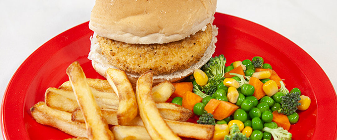 Quorn Burger in a Bun with Chips and Vegetables