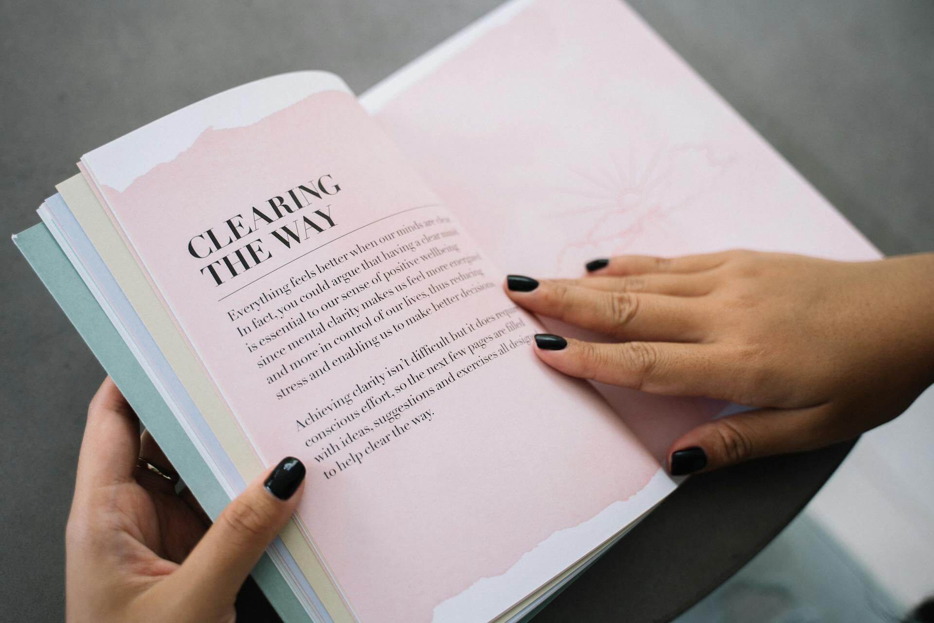 Opened book held by a person (Pexels - Anna Tarazevich)