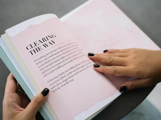 Opened book held by a person (Pexels - Anna Tarazevich)