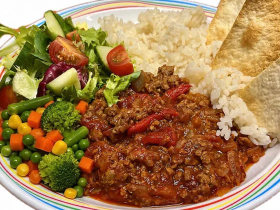 Homemade BBQ beef served with vegetable rice, tortilla chips, salad or mixed vegetables