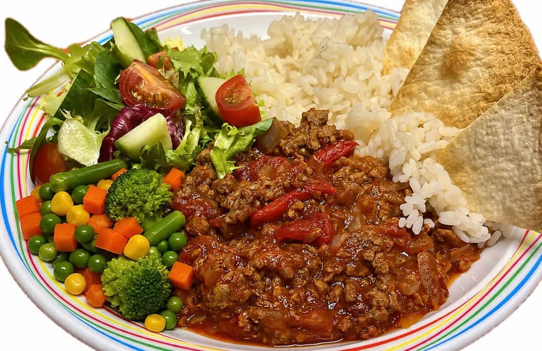 Homemade BBQ beef served with vegetable rice, tortilla chips, salad or mixed vegetables
