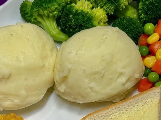 Double bubble salmon fillet served with mash, peas and garlic bread