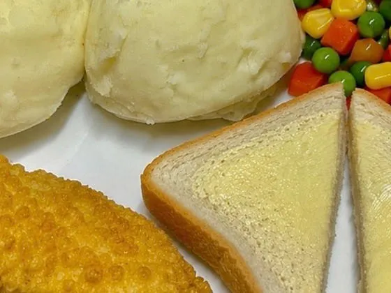 Double bubble salmon fillet served with mash, peas and garlic bread