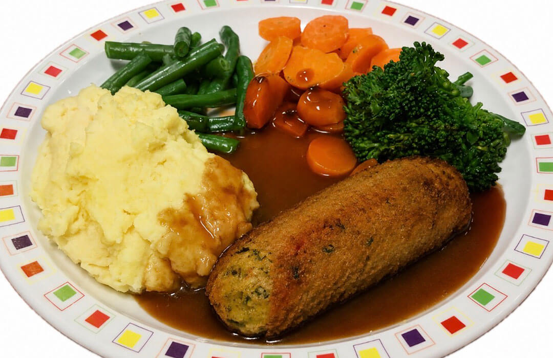 Glamorgan style sausage (V) served with mashed potato, carrots, broccoli and gravy
