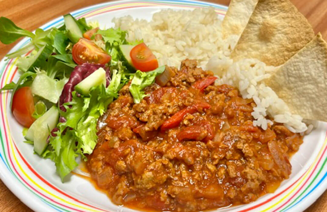 Homemade BBQ Quorn served with vegetable rice, tortilla chips, peas or mixed vegetables