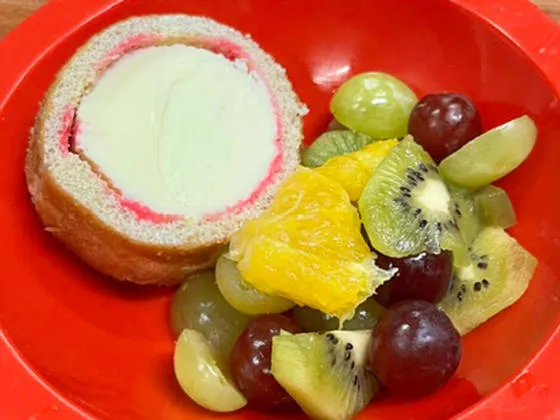 Raspberry and vanilla arctic roll with fruit selection