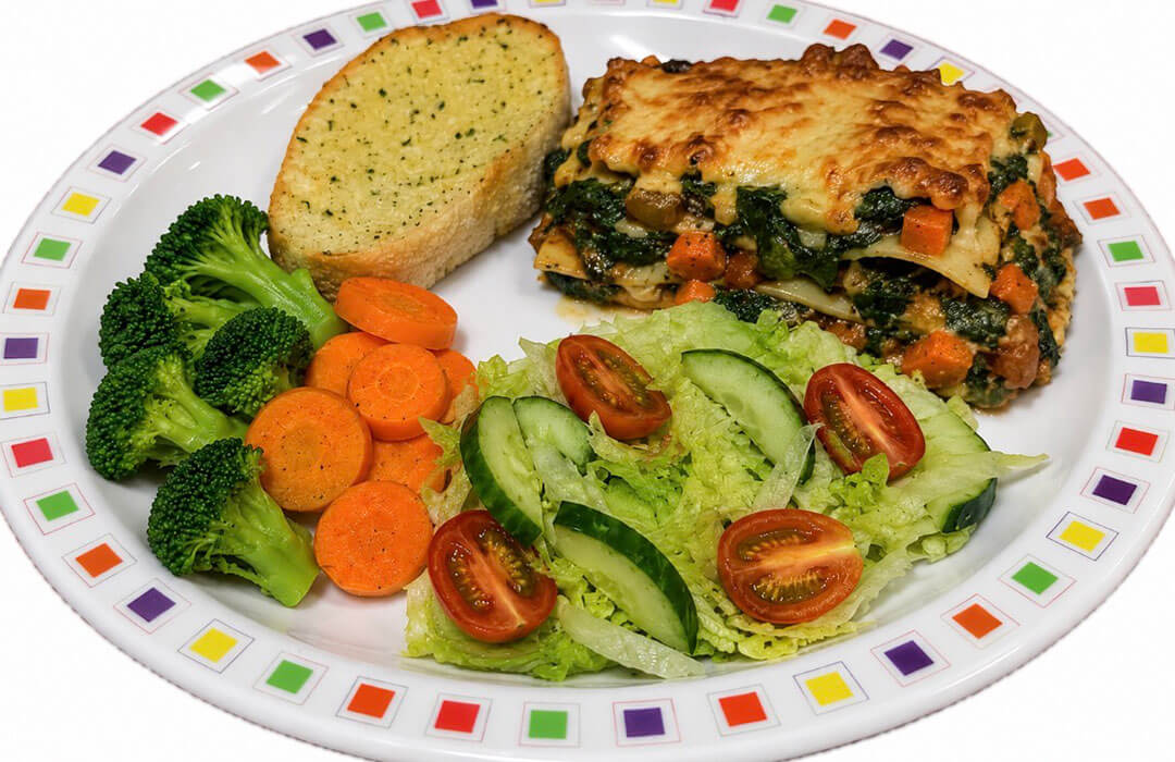 Quorn and spinach lasagne (v) served with garlic bread, vegetables or salad