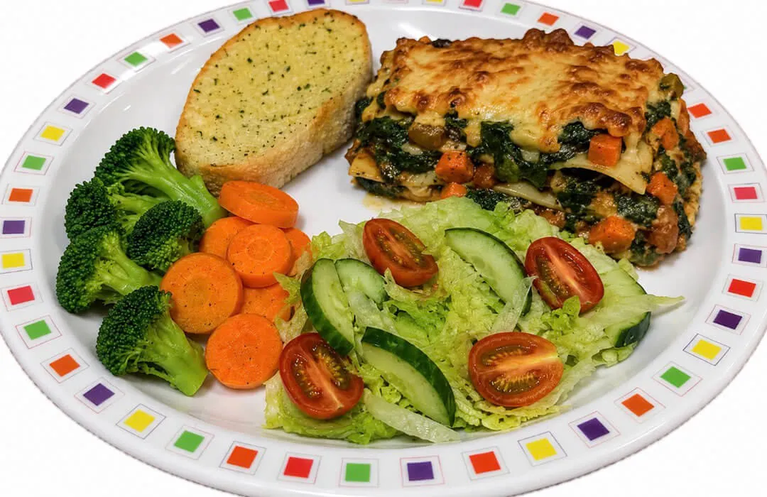 Quorn and spinach lasagne (v) served with garlic bread, vegetables or salad