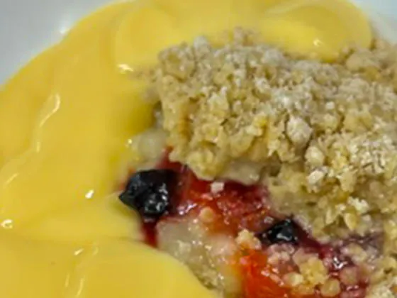 Fruit crumble served with custard