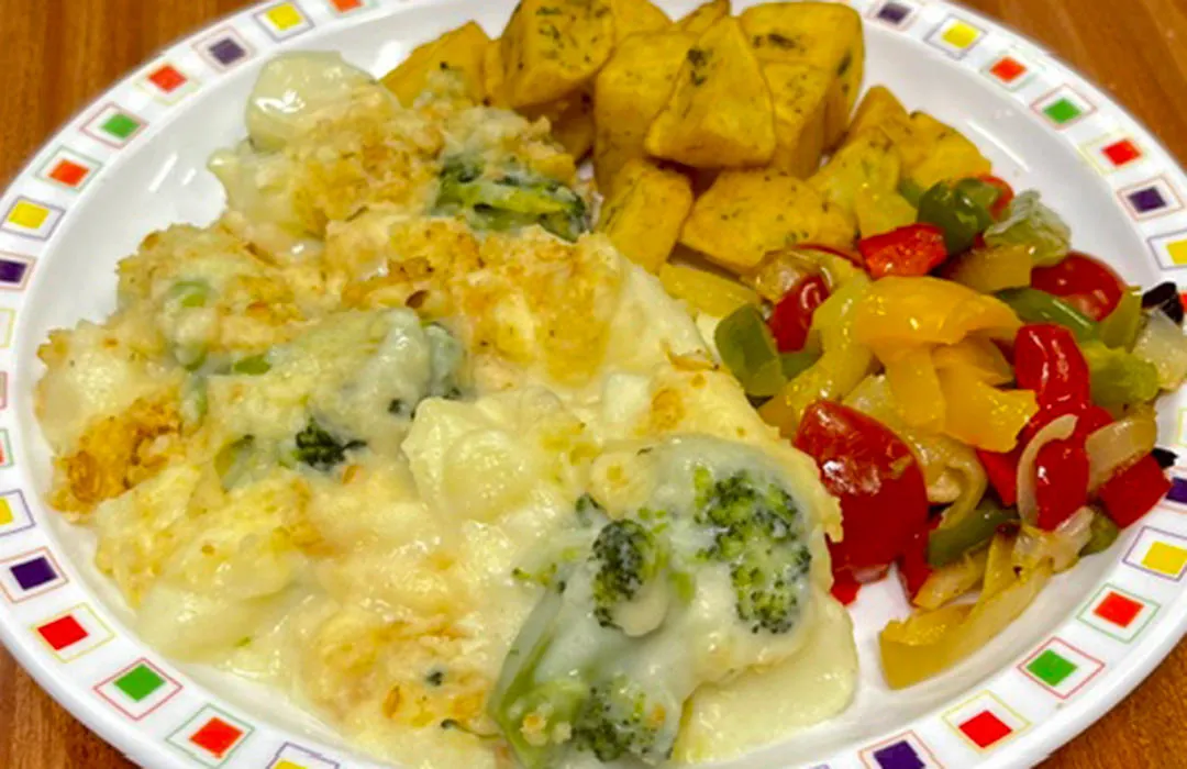 Broccoli and potato bake with a garlic crumb (V) served with Mediterranean roasted vegetables