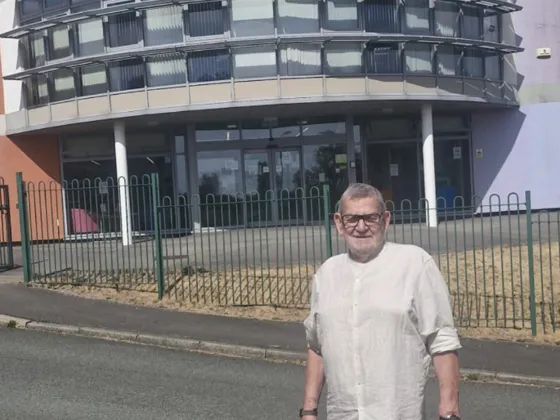 Brian Jones adult learner standing outside the learning centre where he did his gcse