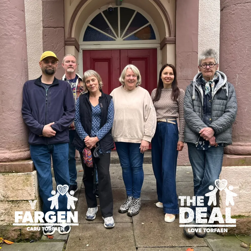 Two men and four women stood outside the entrance to Bethlehem Chapel in Blaenavon with The Deal logo in English and Welsh
