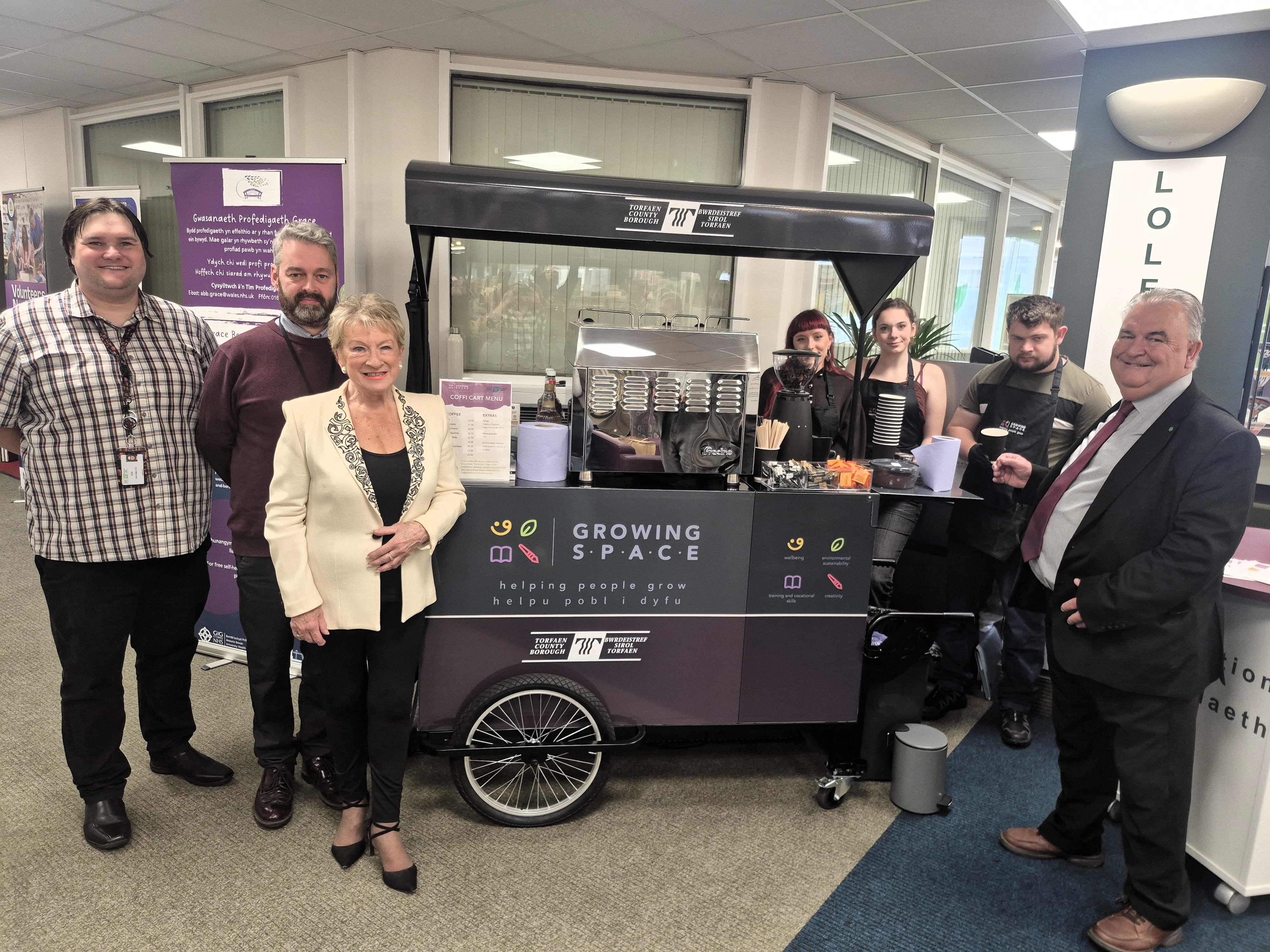 Members of Torfaen Libraries, Growing Space and local councillor photographed in front of Coffi Cart 