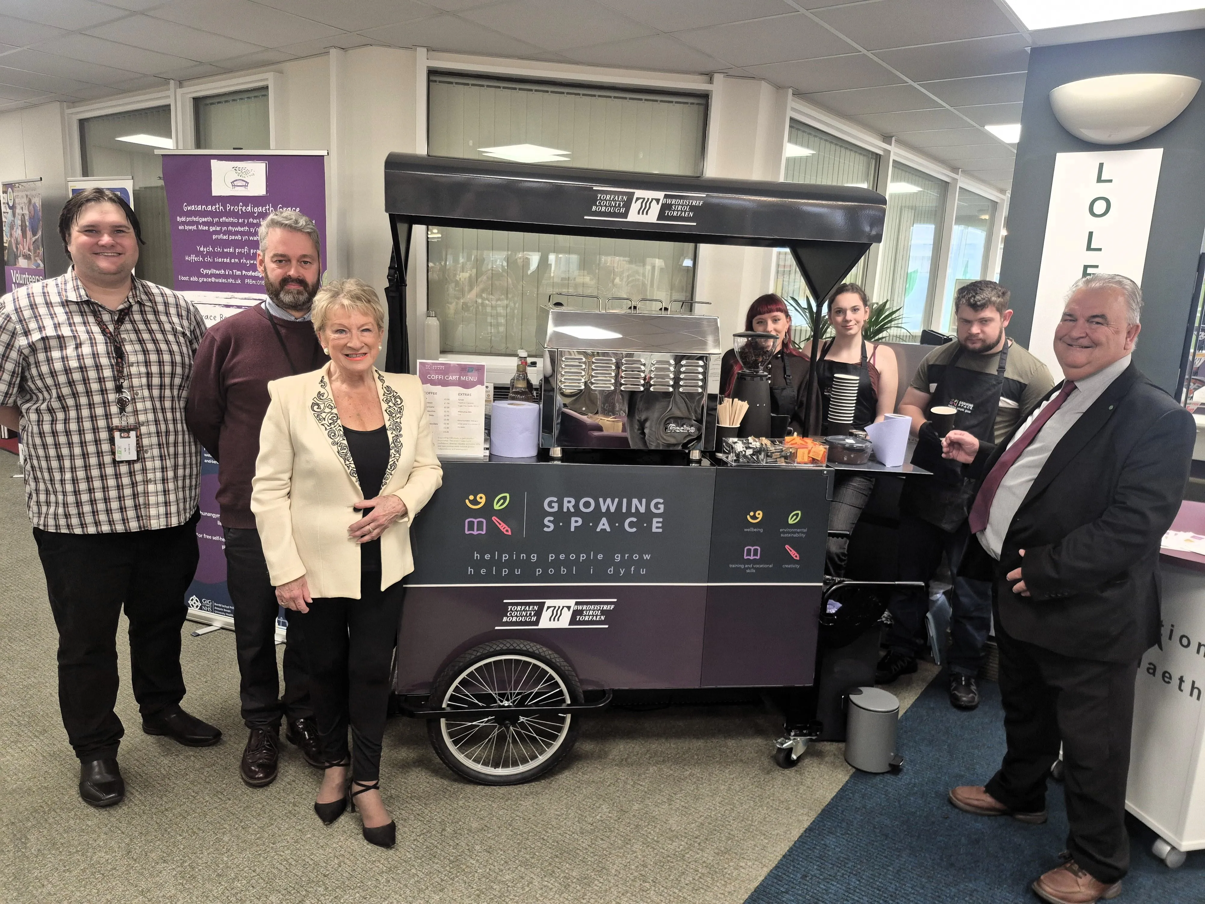 Members of Torfaen Libraries, Growing Space and local councillor photographed in front of Coffi Cart