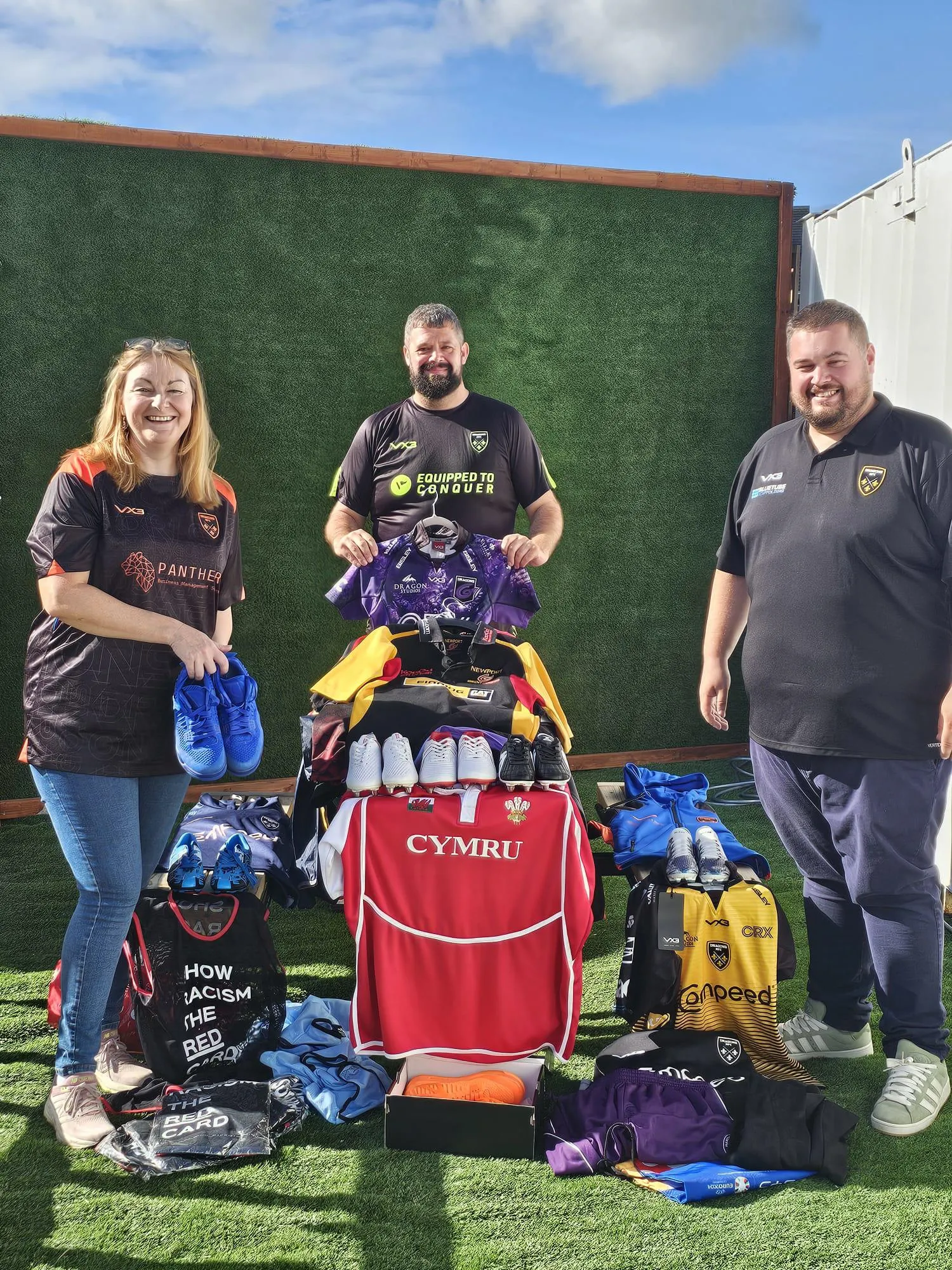 Councillor Fiona Cross pictured with members of Dragons RFC holding donated sports kit.