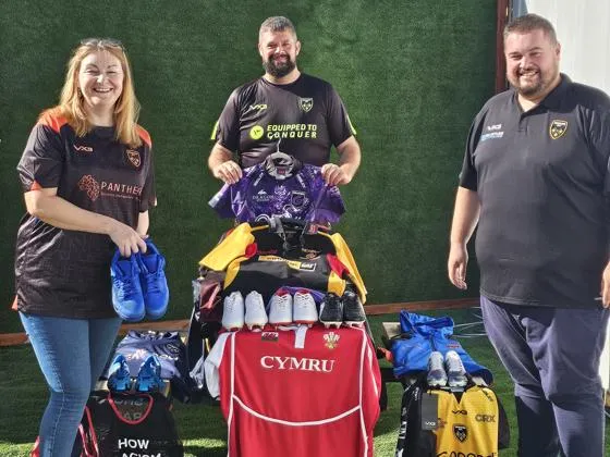Councillor Fiona Cross pictured with members of Dragons RFC holding donated sports kit.