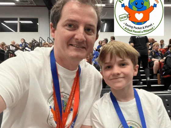 Jon Evans, founder of freeschoolclothes.com, pictured with young boy in a school hall