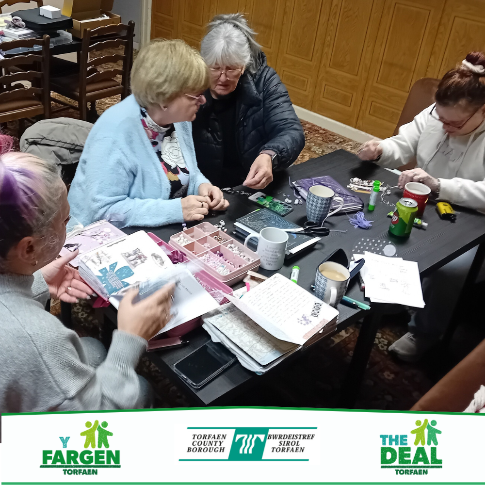 A group of women taking part in a journalling session around a table.
