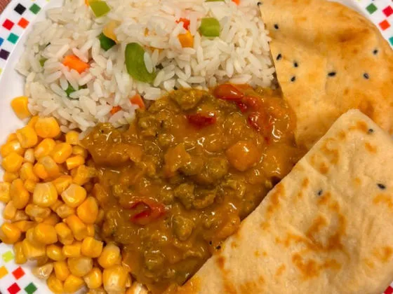 Keema curry served with savoury vegetable rice, sweetcorn and naan bread
