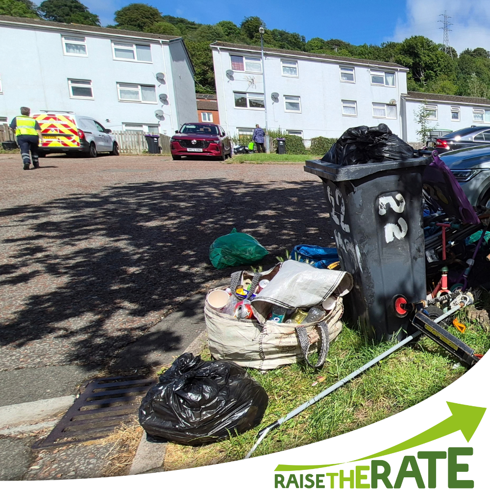 Overflowing purple-lidded bin with additional rubbish bags and a red recycling bag that has incorrect items in it