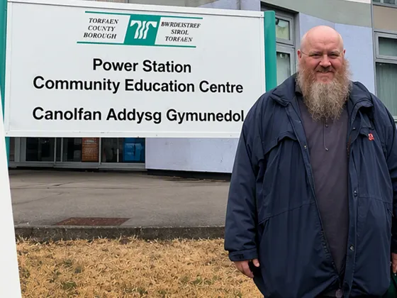 Anthony standing out side the power station smiling