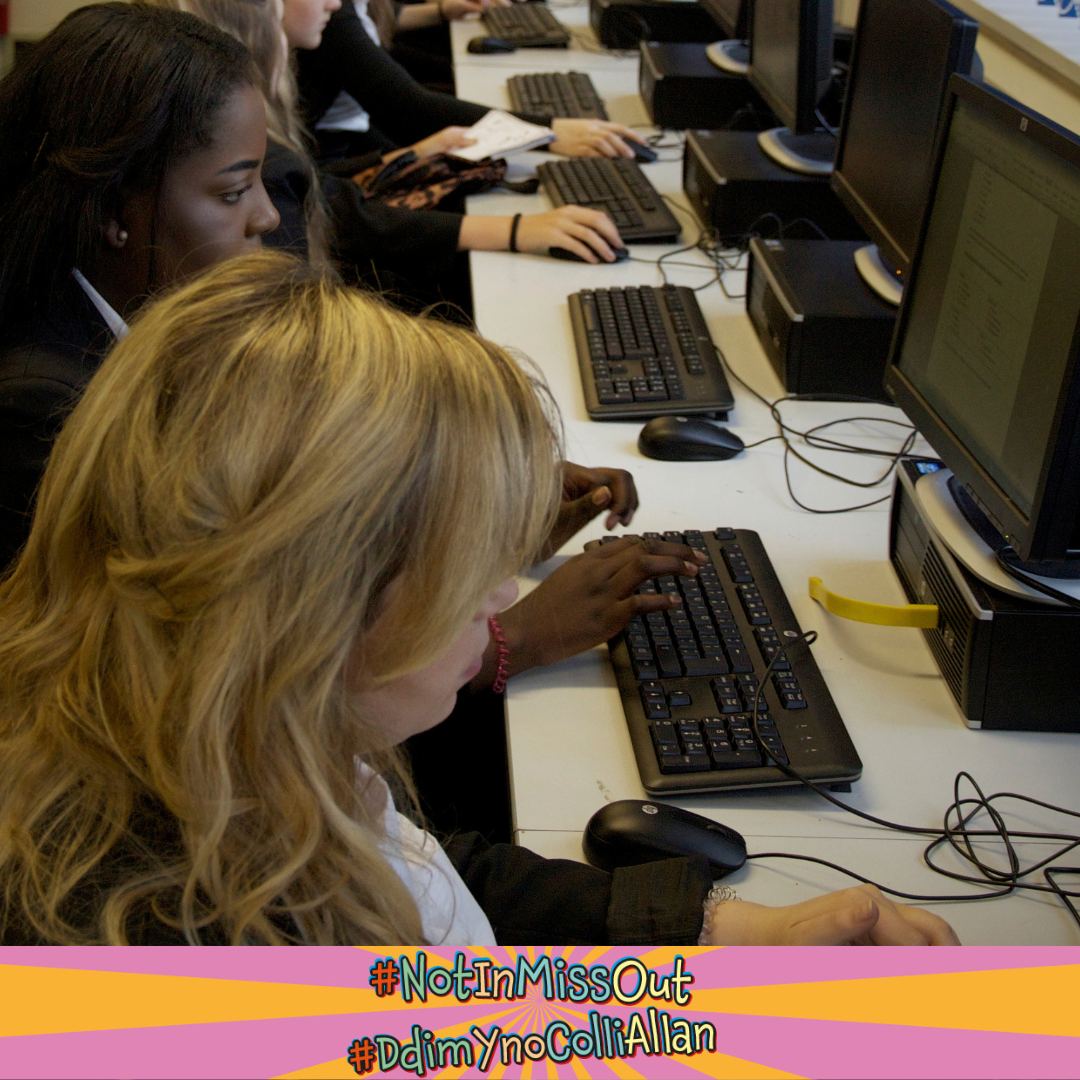 A row of pupils  at desks in an ICT class