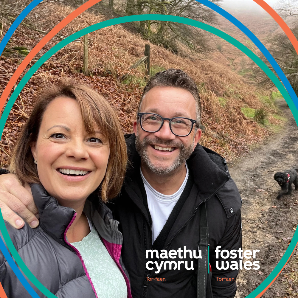 A foster couple who are out on a walk with their dog