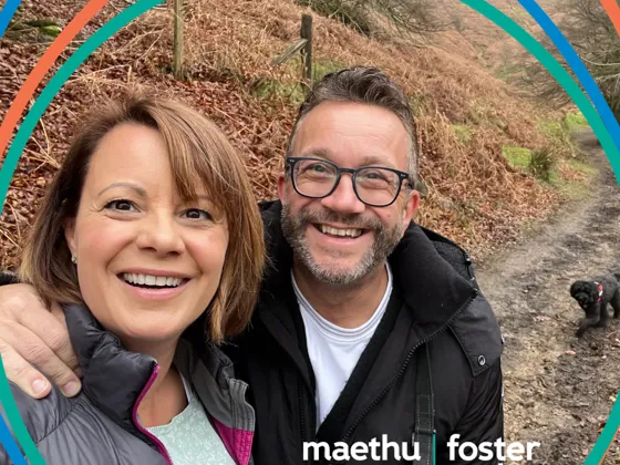 A foster couple who are out on a walk with their dog